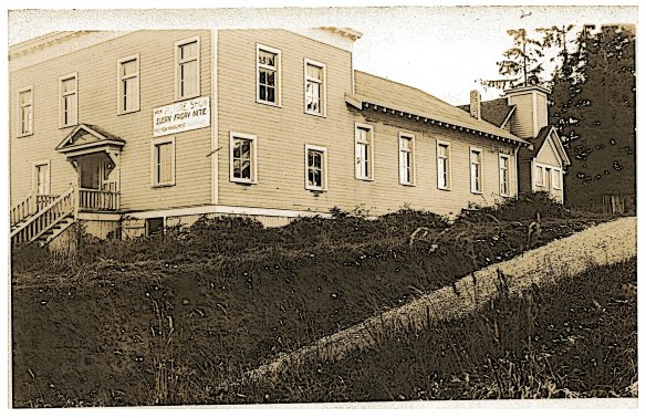 Probably taken in the late `1930's, this view of the Curley Creek Grange shows the original front entrance. It is hard to date this photo, but we believe it is after the 1929 road and bridge were put in, accounting for the steep slope on Harvey Avenue. The sign on the front reads, "New Picture Show Each Friday; Under New Management." From the McFate Family Collection.
